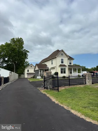 a front view of house with yard and trees