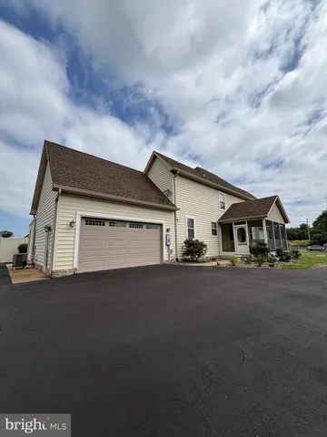 a view of a house with a yard and garage