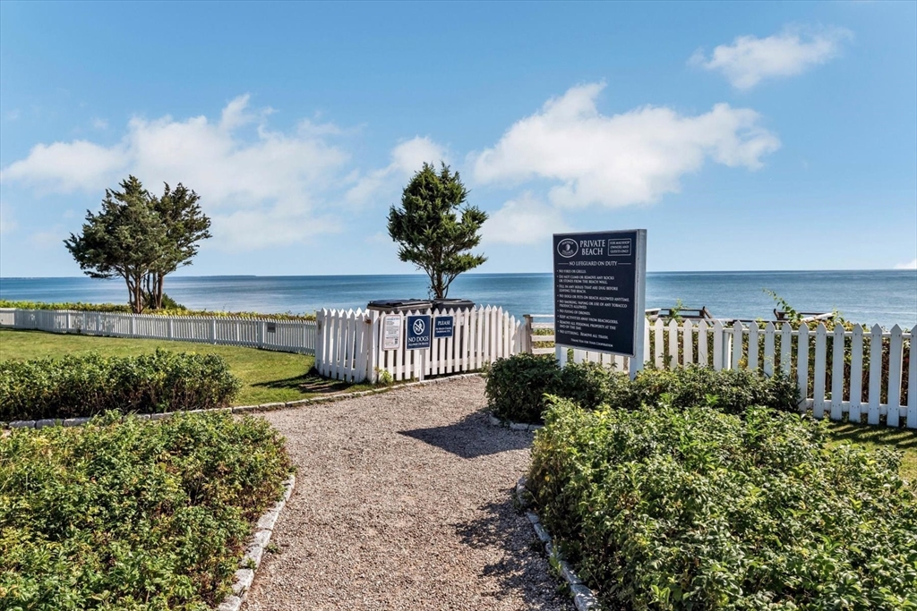 36 Brant Rock Road, Unit 821 Mashpee, MA 02649 - Photo 20 of 23 a view of a flower in front of a house