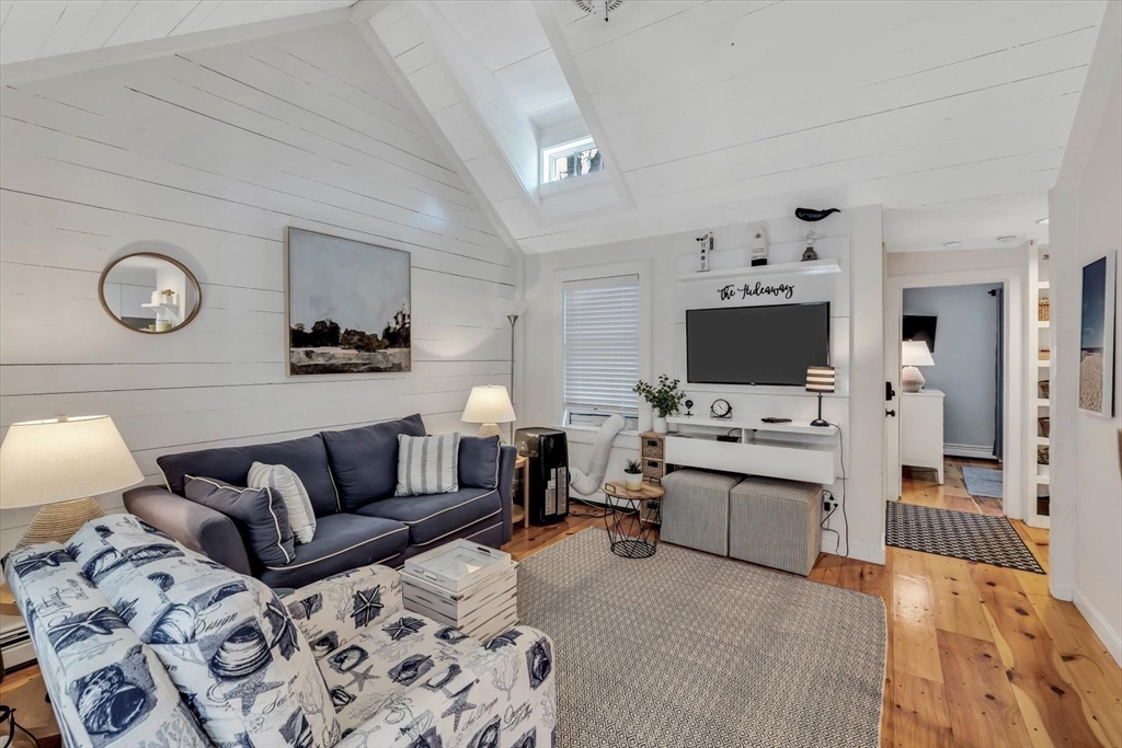 36 Brant Rock Road, Unit 821 Mashpee, MA 02649 - Photo 6 of 23 a living room with furniture and a flat screen tv