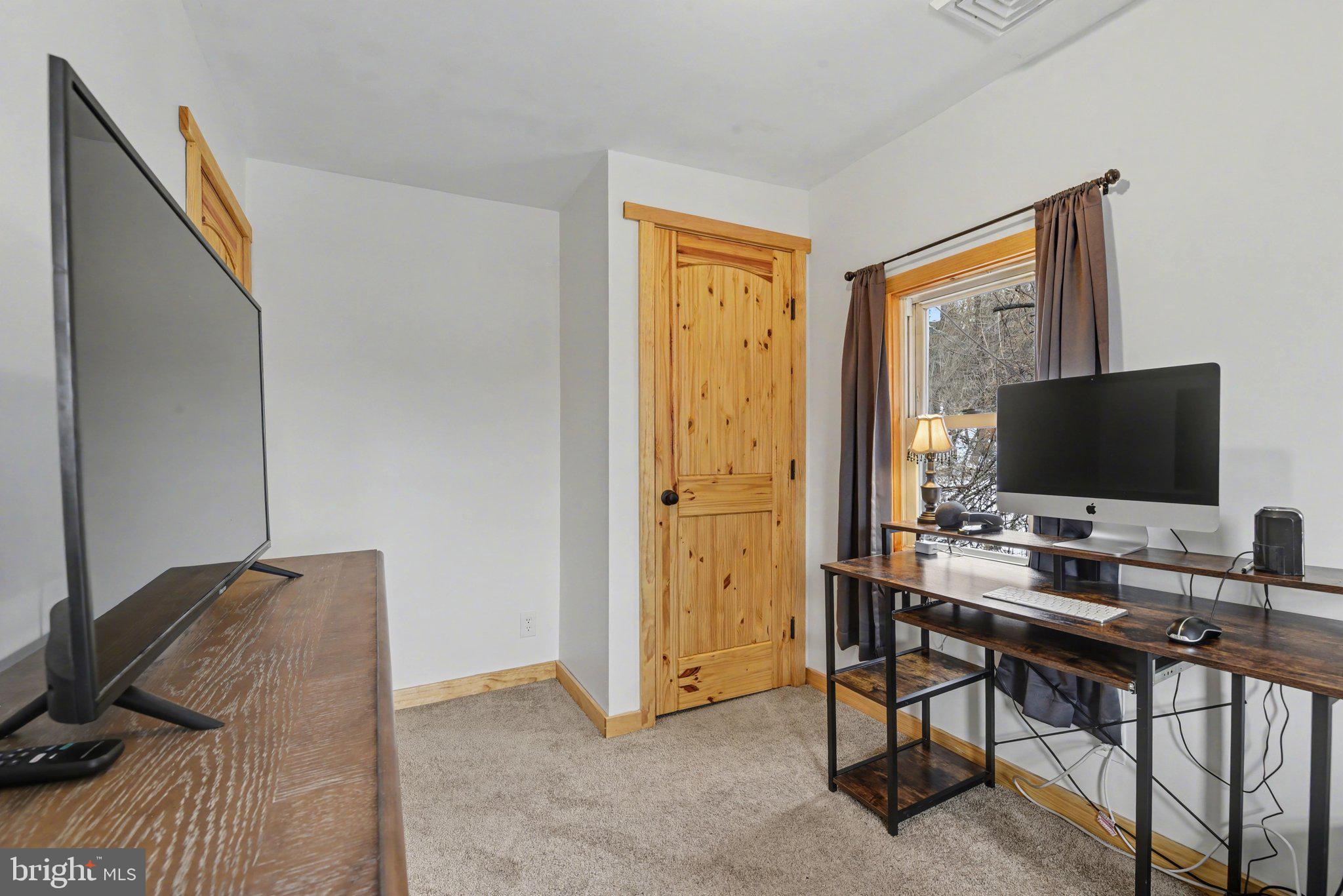1117 State Road Duncannon, PA 17020 - Photo 24 of 29 a view of a livingroom with workspace and a flat screen tv
