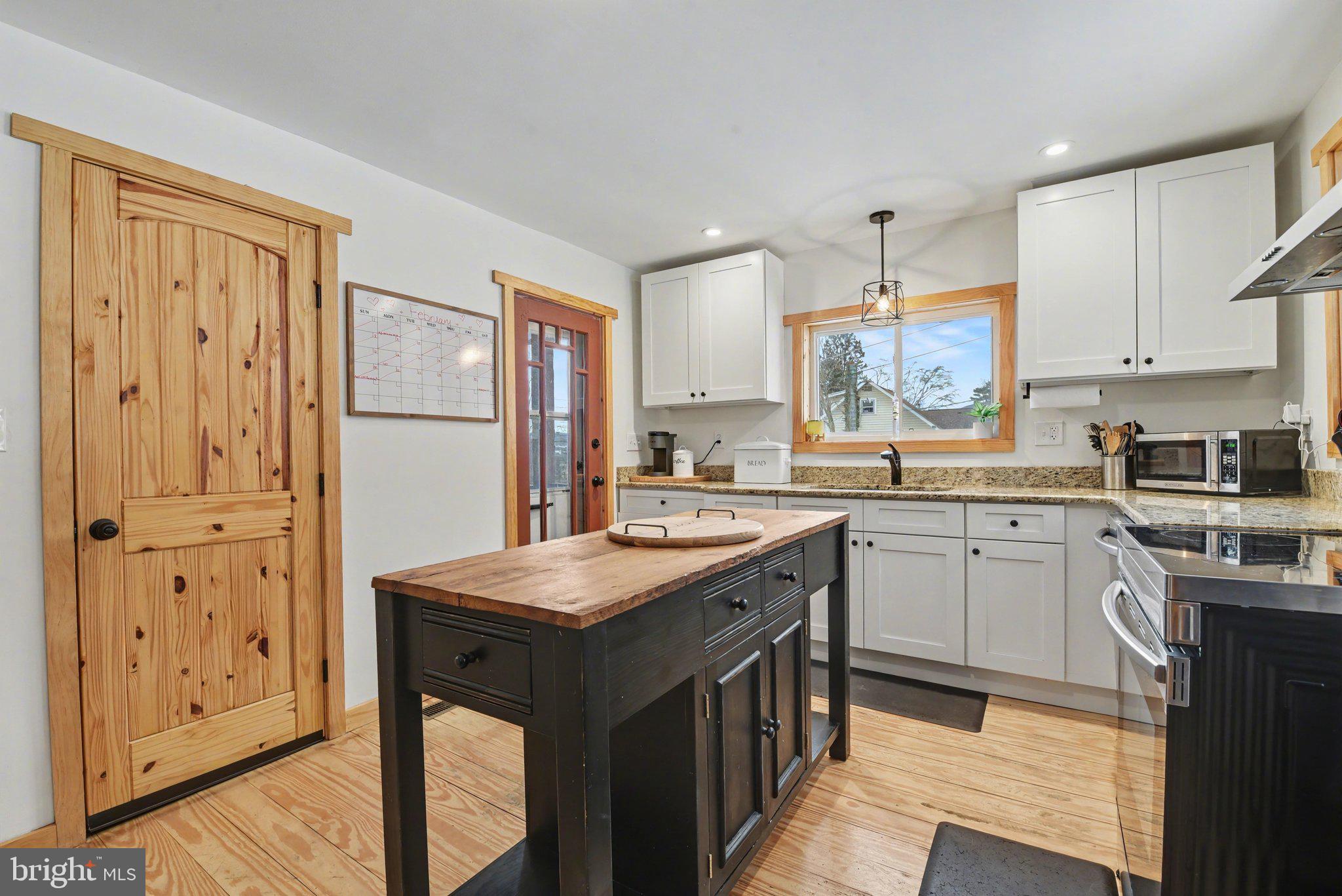 1117 State Road Duncannon, PA 17020 - Photo 4 of 29 a kitchen with a sink a stove a refrigerator and white cabinets