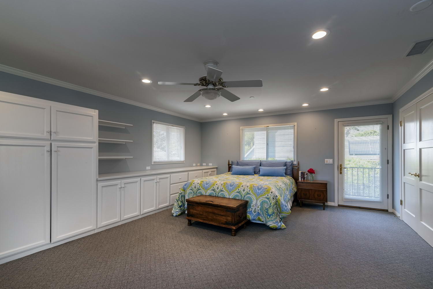 166 Toro Canyon Road Carpinteria, CA 93013 - Photo 9 of 11 a spacious bedroom with a bed and a chandelier