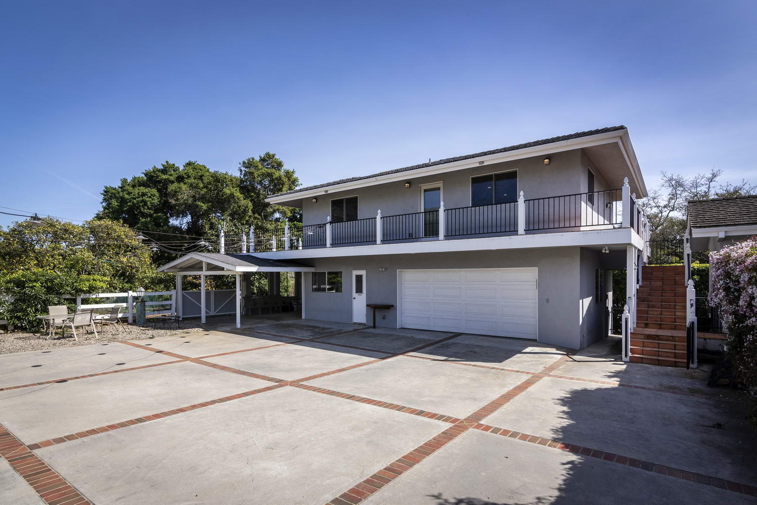 166 Toro Canyon Road Carpinteria, CA 93013 - Photo 10 of 11 a front view of a house with a garden