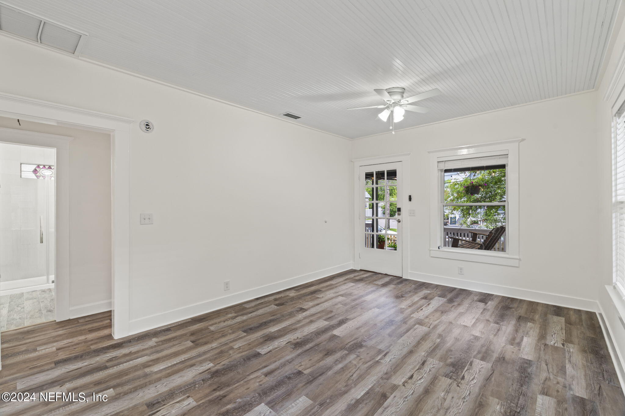 64 Carrera Street St. Augustine, FL 32084 - Photo 13 of 84 an empty room with wooden floor chandelier fan and windows