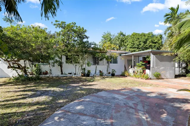 a front view of a house with a yard and a garage