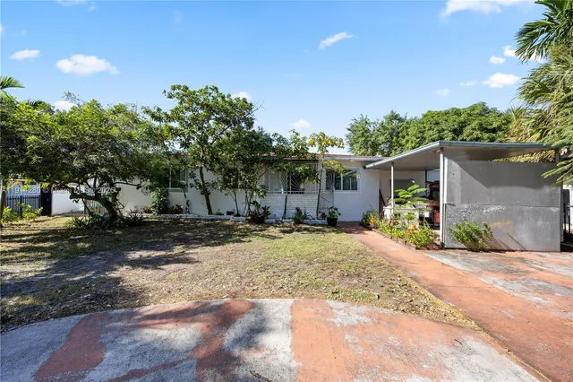 a front view of a house with a yard and a garage
