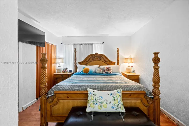 a bed room with a bed and a chandelier