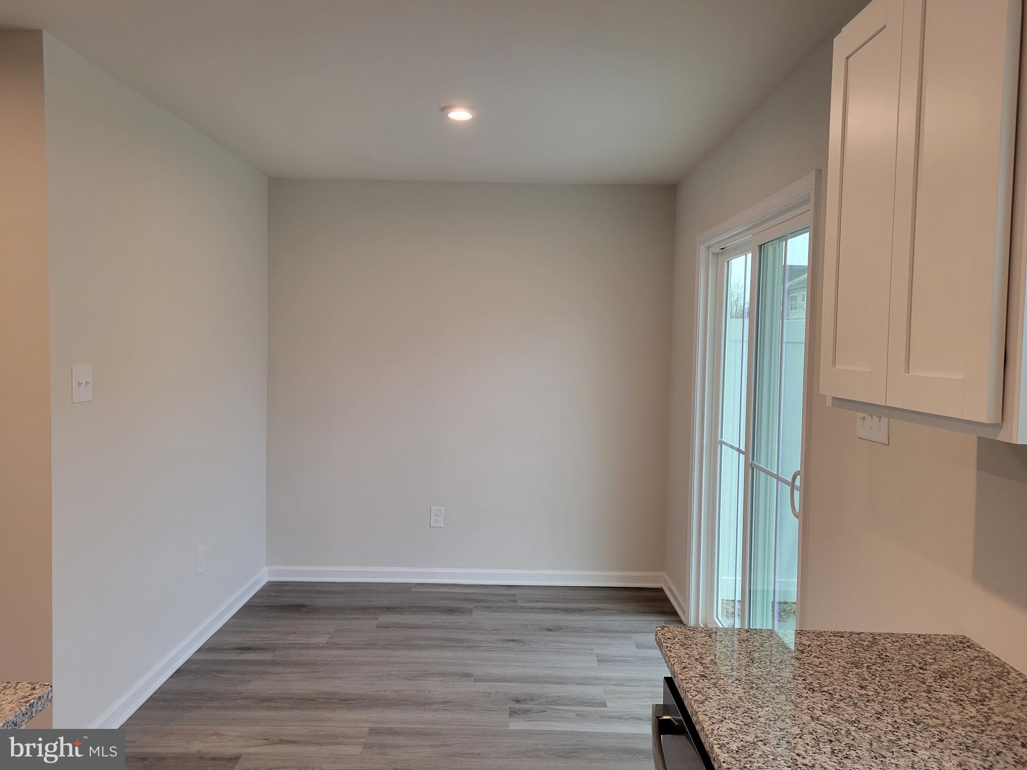 24 Mulberry Lane Clementon, NJ 08021 - Photo 6 of 13 an empty room with wooden floor and door