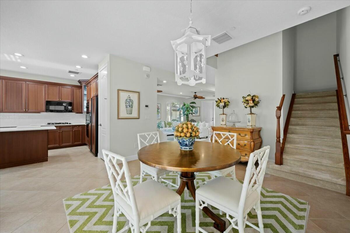 222 Tresana Boulevard, Unit 44 Jupiter, FL 33478 - Photo 11 of 63 a view of a dining room with furniture and chandelier
