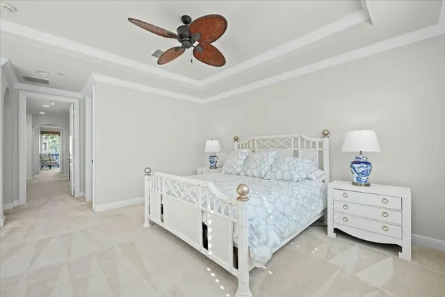 a bedroom with a bed and a ceiling fan