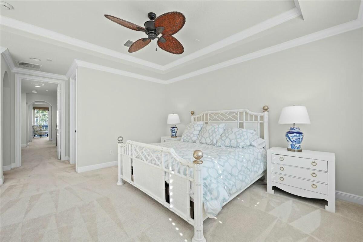 222 Tresana Boulevard, Unit 44 Jupiter, FL 33478 - Photo 17 of 63 a bedroom with a bed and a ceiling fan