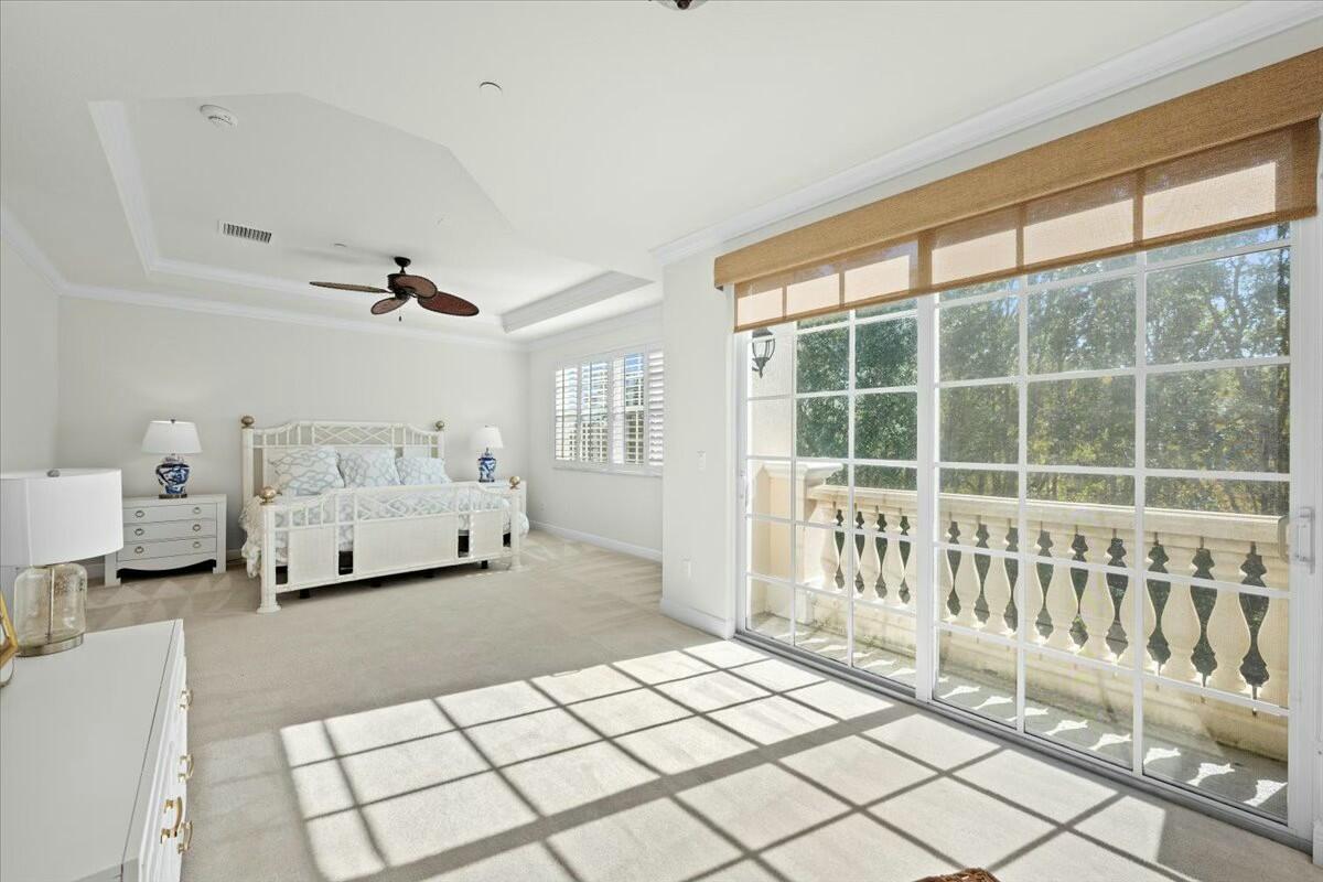 222 Tresana Boulevard, Unit 44 Jupiter, FL 33478 - Photo 18 of 63 a spacious bedroom with a bed and a large window
