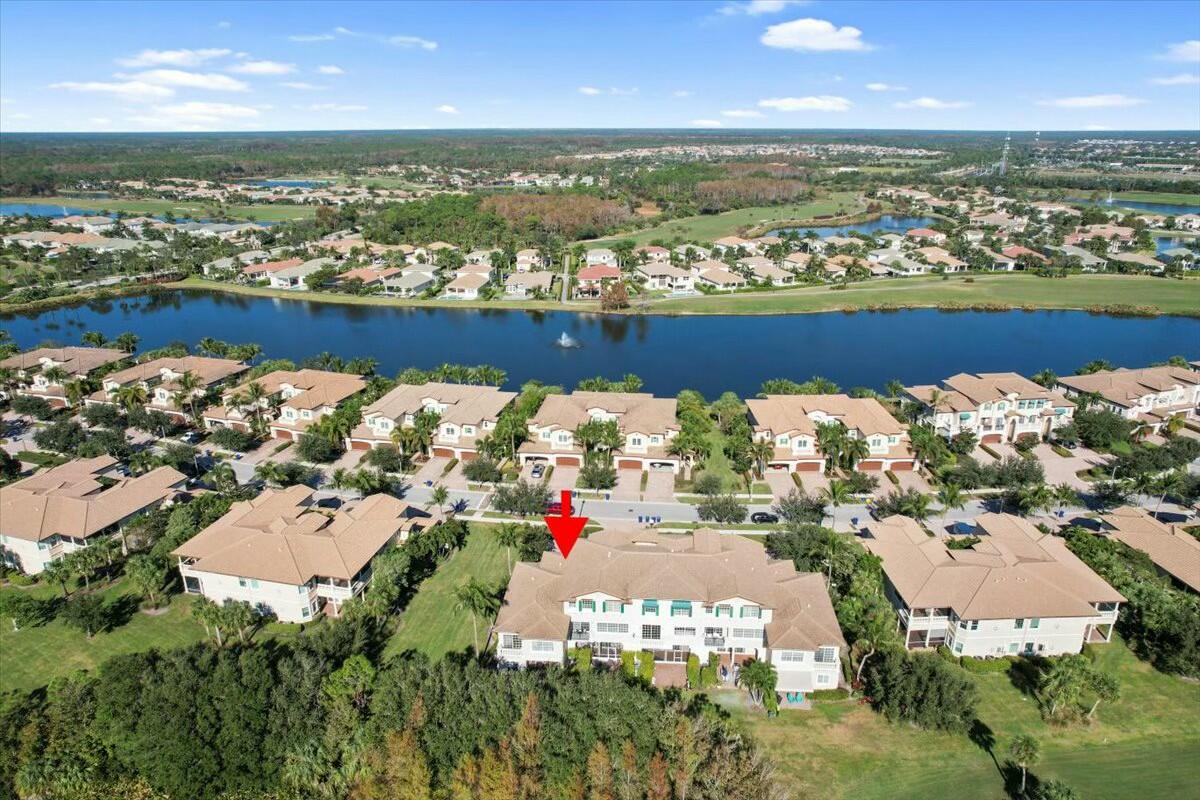 222 Tresana Boulevard, Unit 44 Jupiter, FL 33478 - Photo 37 of 63 an aerial view of a city with lots of residential buildings ocean and mountain view in back
