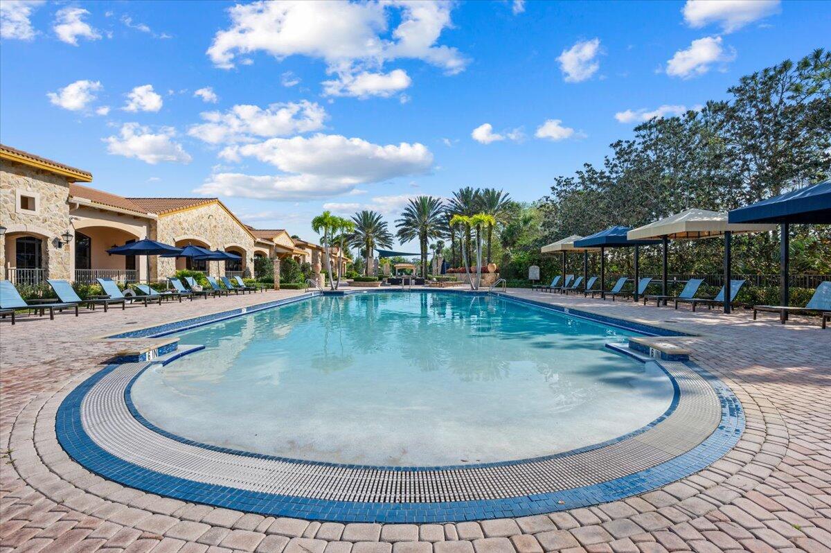 222 Tresana Boulevard, Unit 44 Jupiter, FL 33478 - Photo 60 of 63 a view of a swimming pool with an outdoor seating