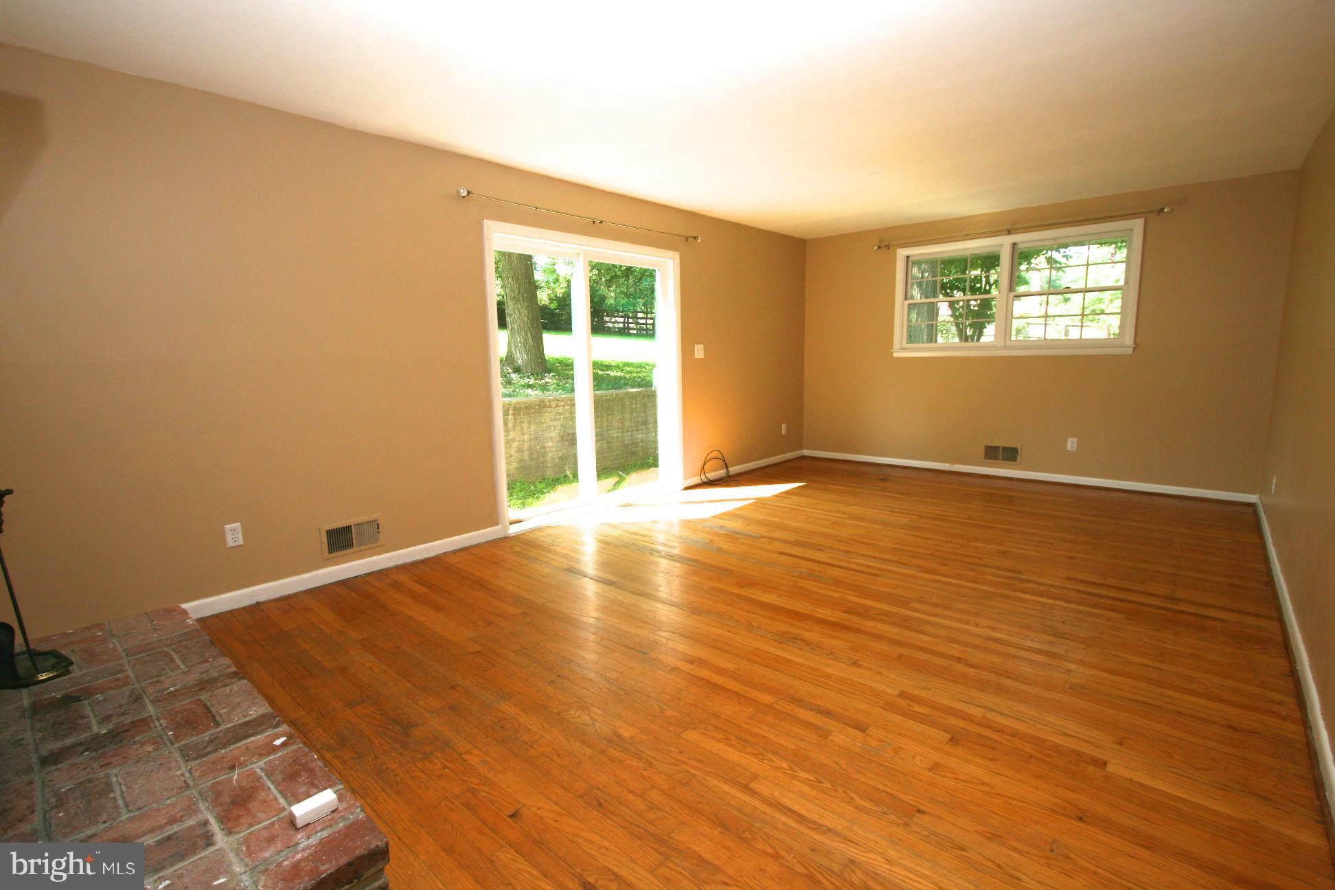 9429 Dartmouth Road Columbia, MD 21045 - Photo 2 of 27 a view of an empty room with wooden floor and a window