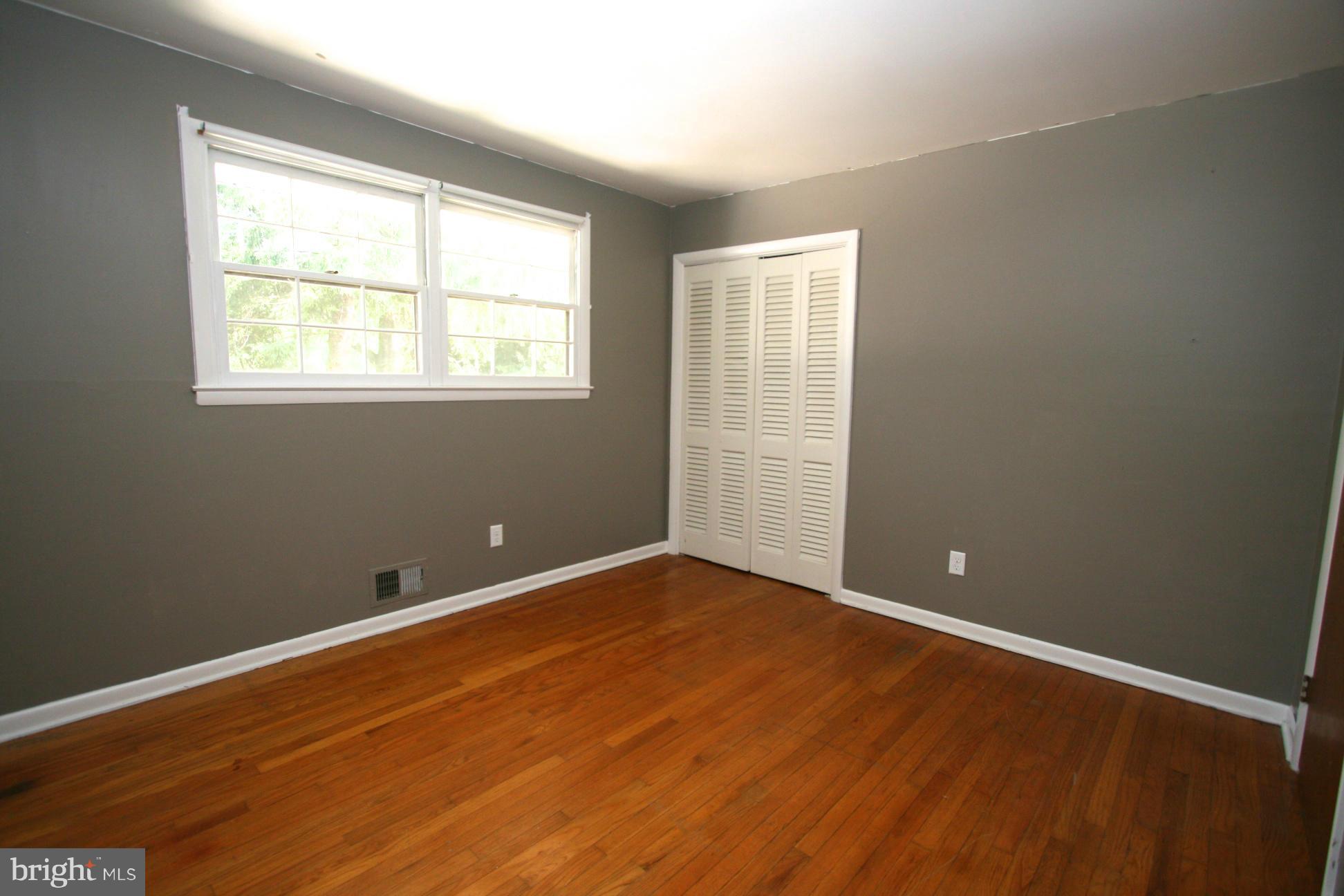 9429 Dartmouth Road Columbia, MD 21045 - Photo 17 of 27 an empty room with wooden floor and windows