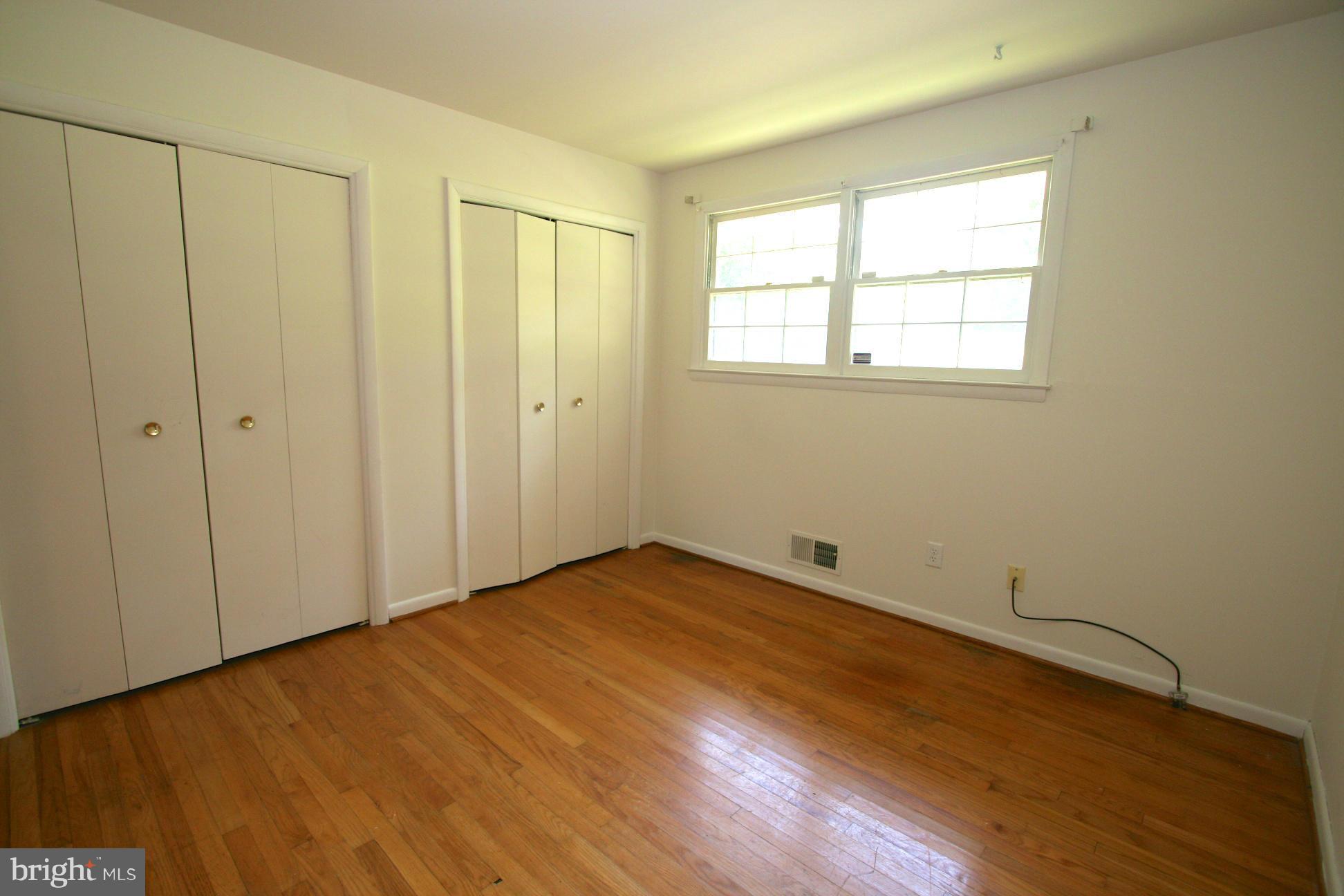 9429 Dartmouth Road Columbia, MD 21045 - Photo 18 of 27 a view of an empty room with wooden floor and a window