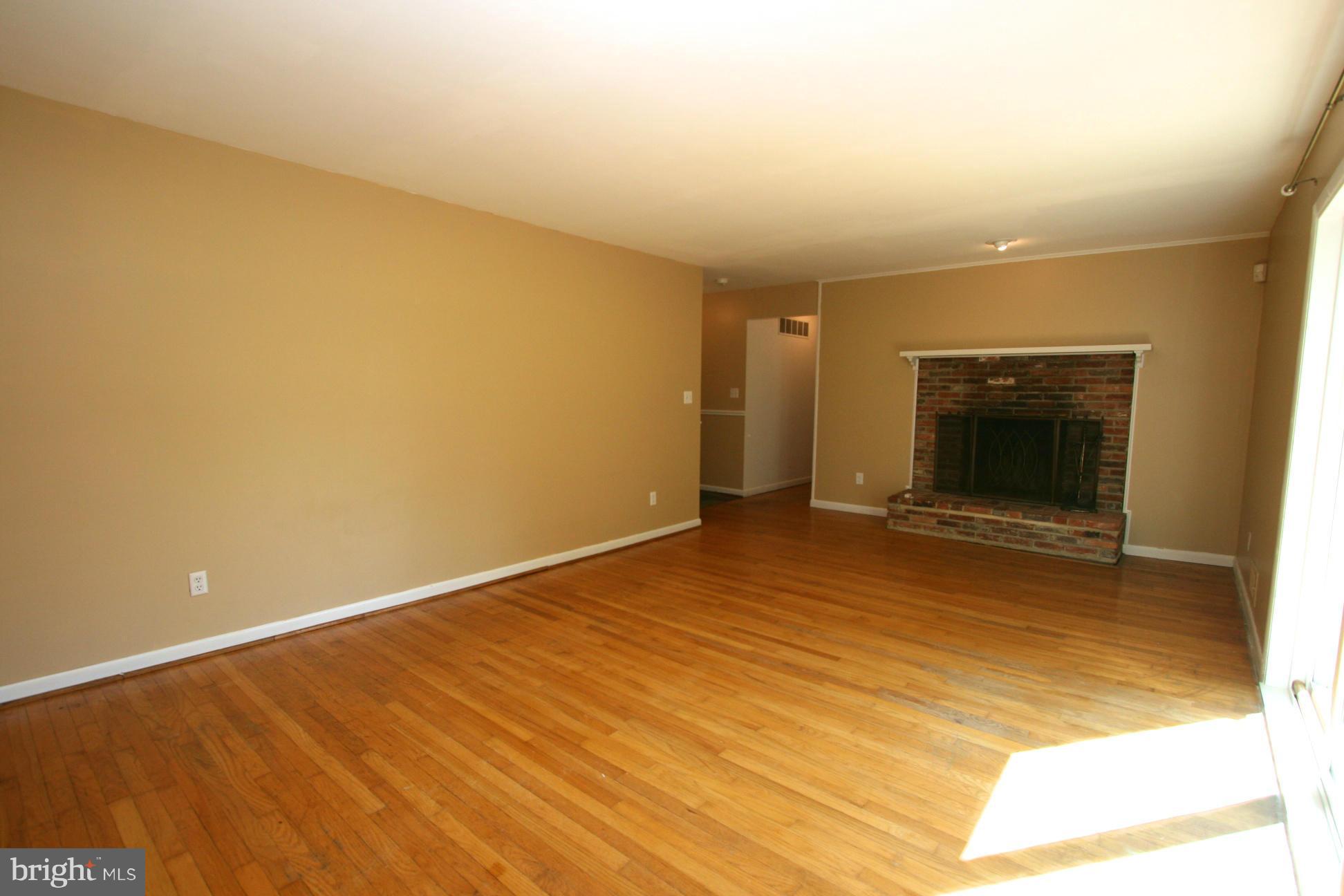9429 Dartmouth Road Columbia, MD 21045 - Photo 3 of 27 a view of an empty room with wooden floor and a window