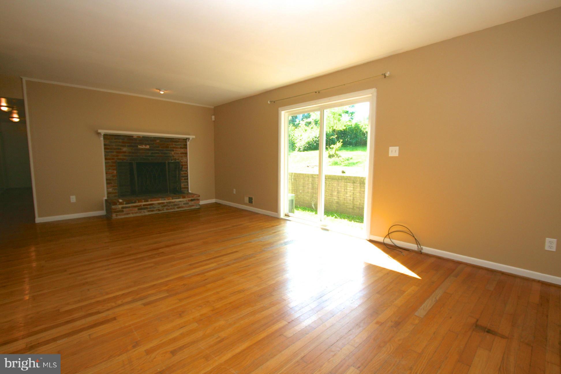 9429 Dartmouth Road Columbia, MD 21045 - Photo 4 of 27 an empty room with wooden floor and windows