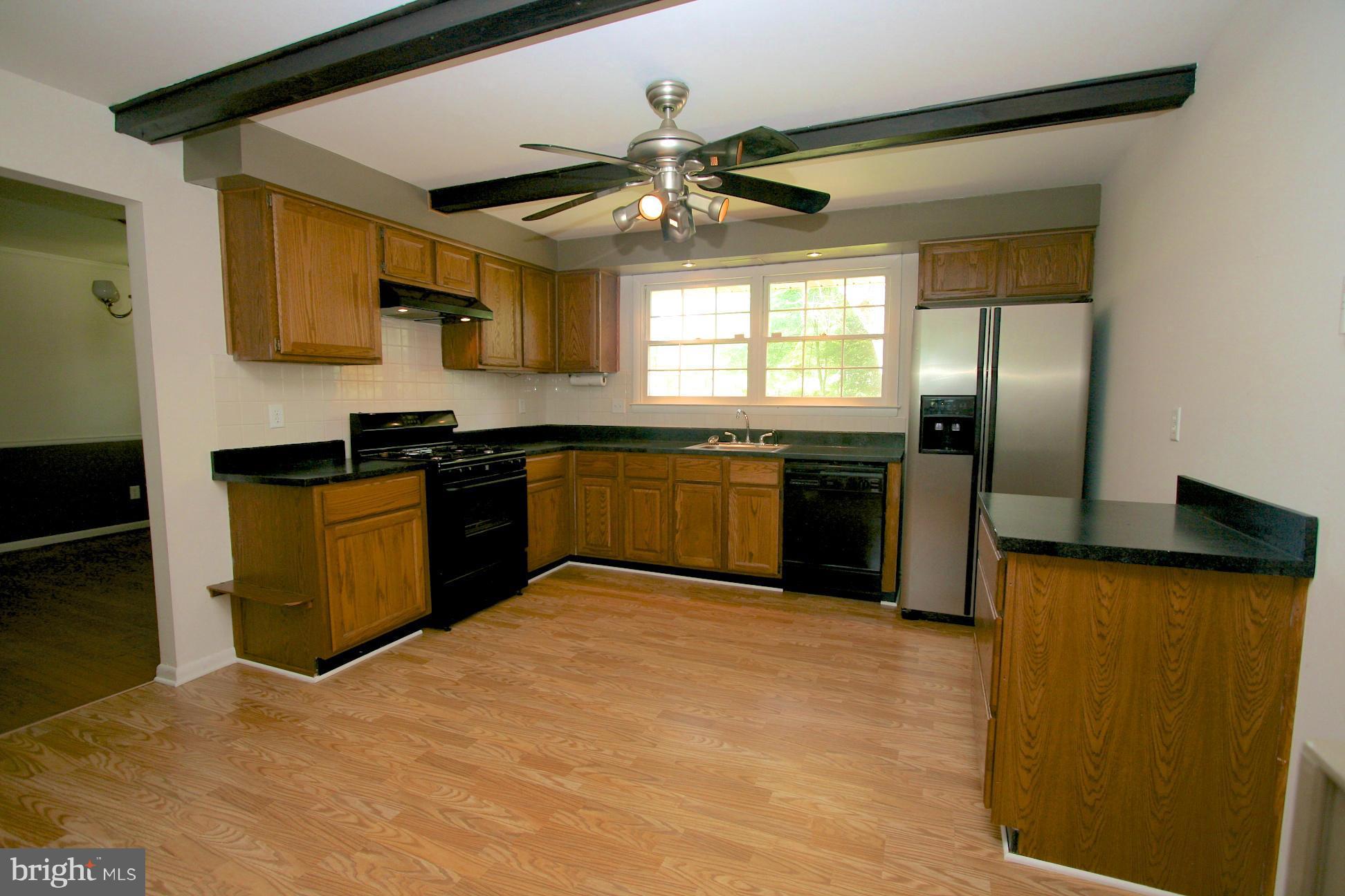 9429 Dartmouth Road Columbia, MD 21045 - Photo 6 of 27 a kitchen with stainless steel appliances granite countertop a sink and a refrigerator