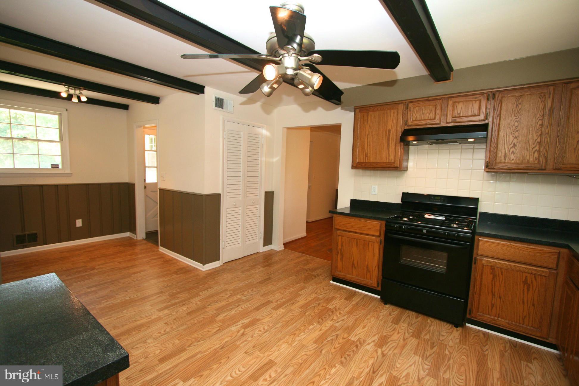 9429 Dartmouth Road Columbia, MD 21045 - Photo 7 of 27 a kitchen with stainless steel appliances granite countertop a sink and a stove