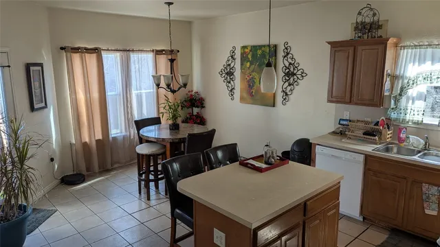 a kitchen with a table chairs and a refrigerator