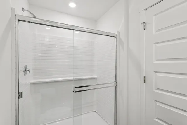 a bathroom with a glass shower door