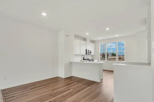a kitchen with kitchen island sink stove and cabinets