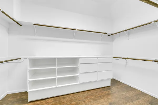a view of walk in closet with empty racks