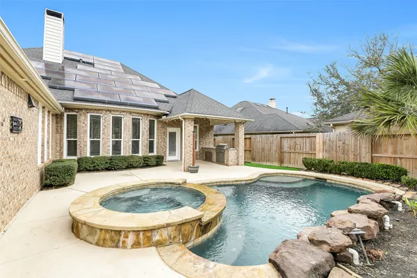 a view of a house with swimming pool and sitting area