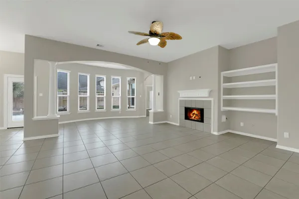 a view of an empty room with a fireplace and a window