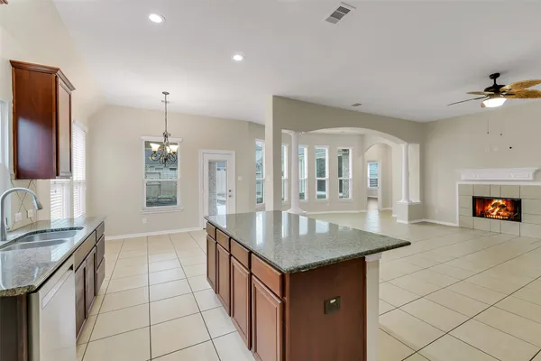 a kitchen with granite countertop a sink and a refrigerator