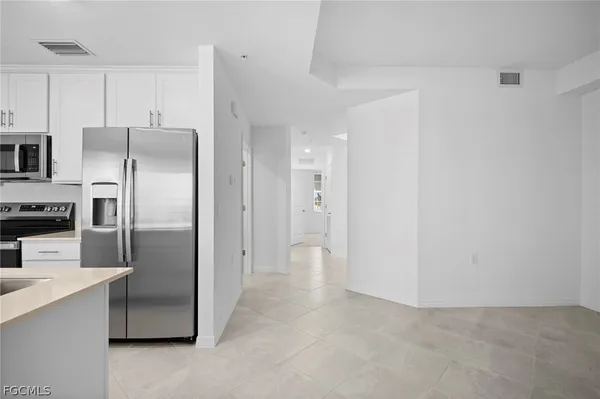 a kitchen with stainless steel appliances a refrigerator and a stove