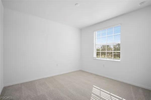 a view of a room with wooden floor and cabinet