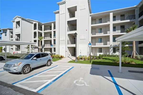 a front view of a residential apartment building with a yard