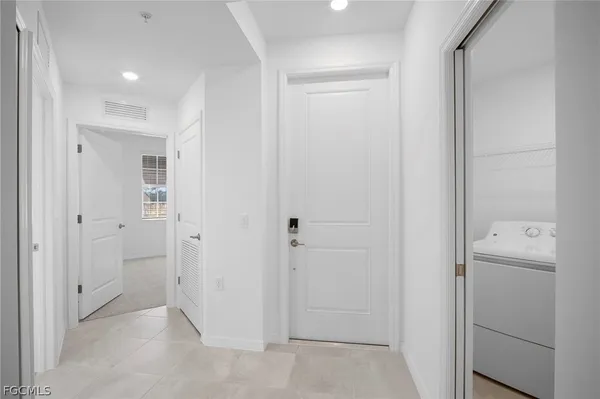 a view of a hallway with closet and bathroom