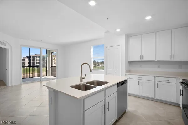 a kitchen with sink and refrigerator