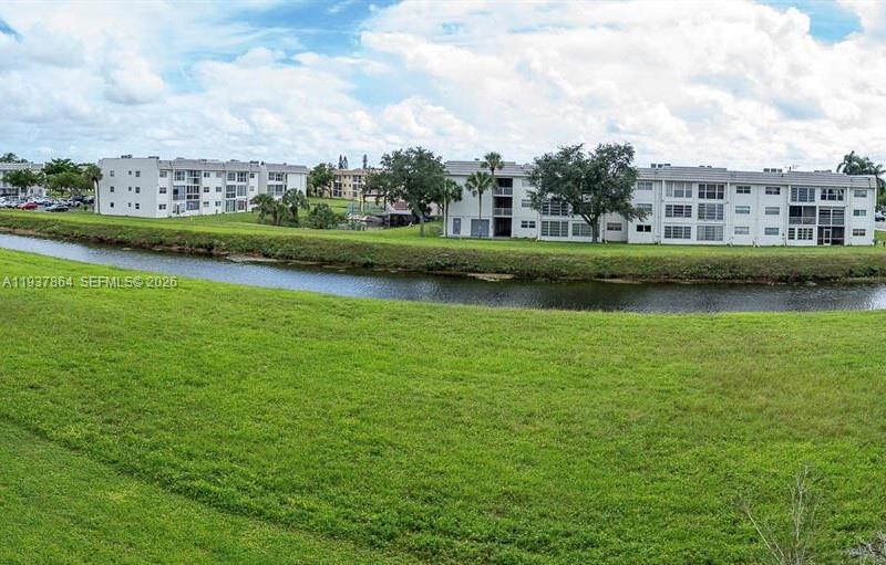 3120 North Pine Island Road, Unit 307 Sunrise, FL 33351 - Photo 14 of 17 an aerial view of a house with a garden and lake view