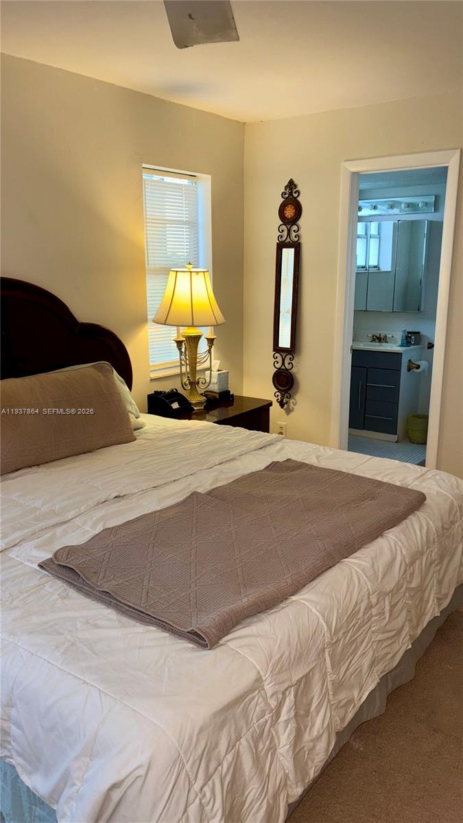 3120 North Pine Island Road, Unit 307 Sunrise, FL 33351 - Photo 7 of 17 a bedroom with a bed and a lamp