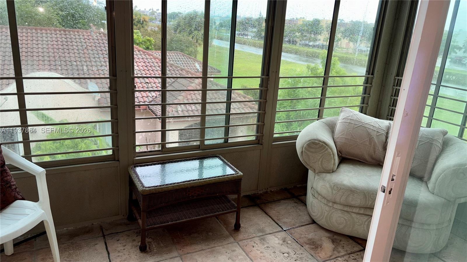 3120 North Pine Island Road, Unit 307 Sunrise, FL 33351 - Photo 8 of 17 a living room with furniture and a window