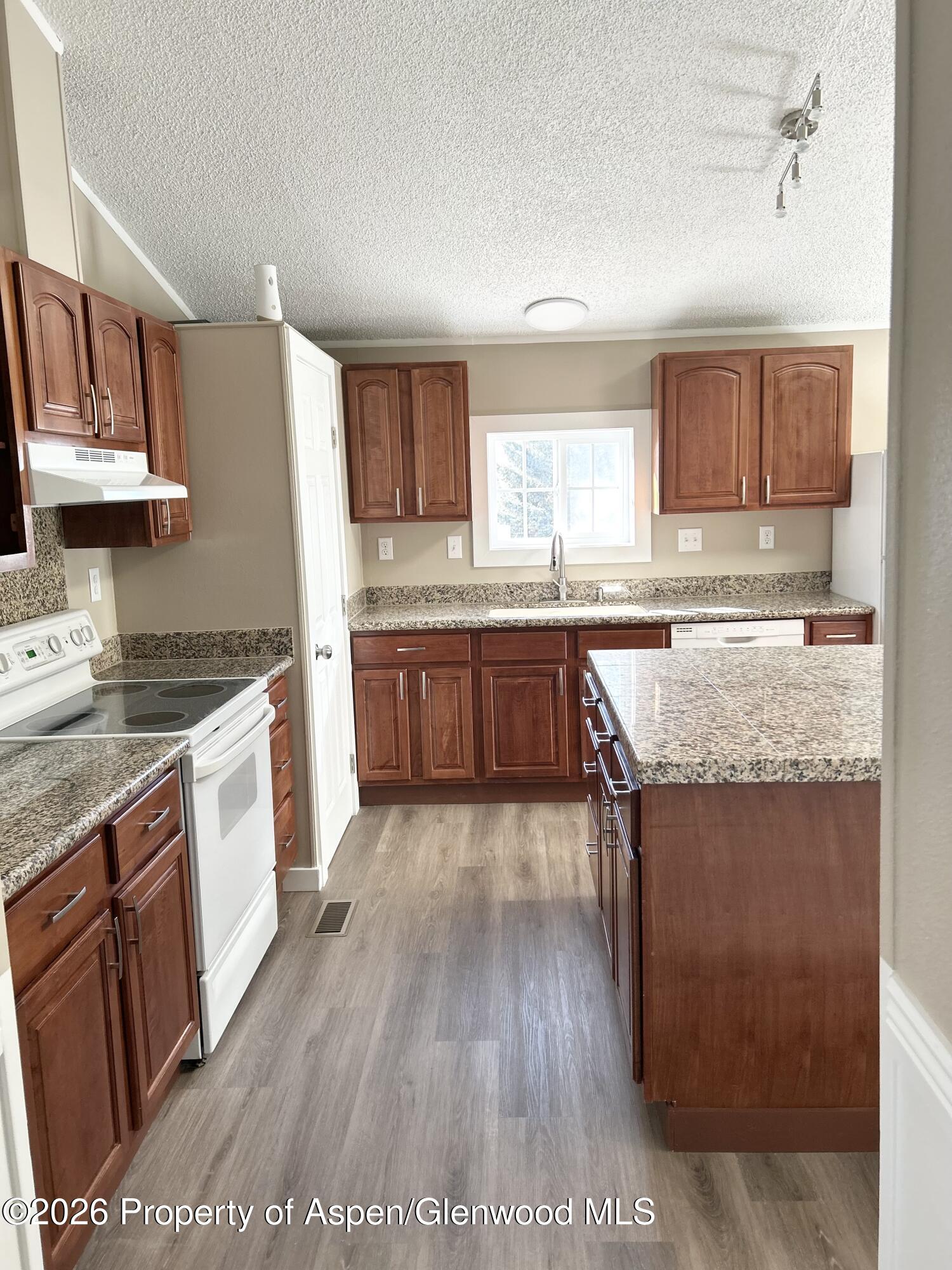 665 Conner Drive Craig, CO 81625 - Photo 7 of 31 a kitchen with stainless steel appliances granite countertop a stove a sink dishwasher and a refrigerator