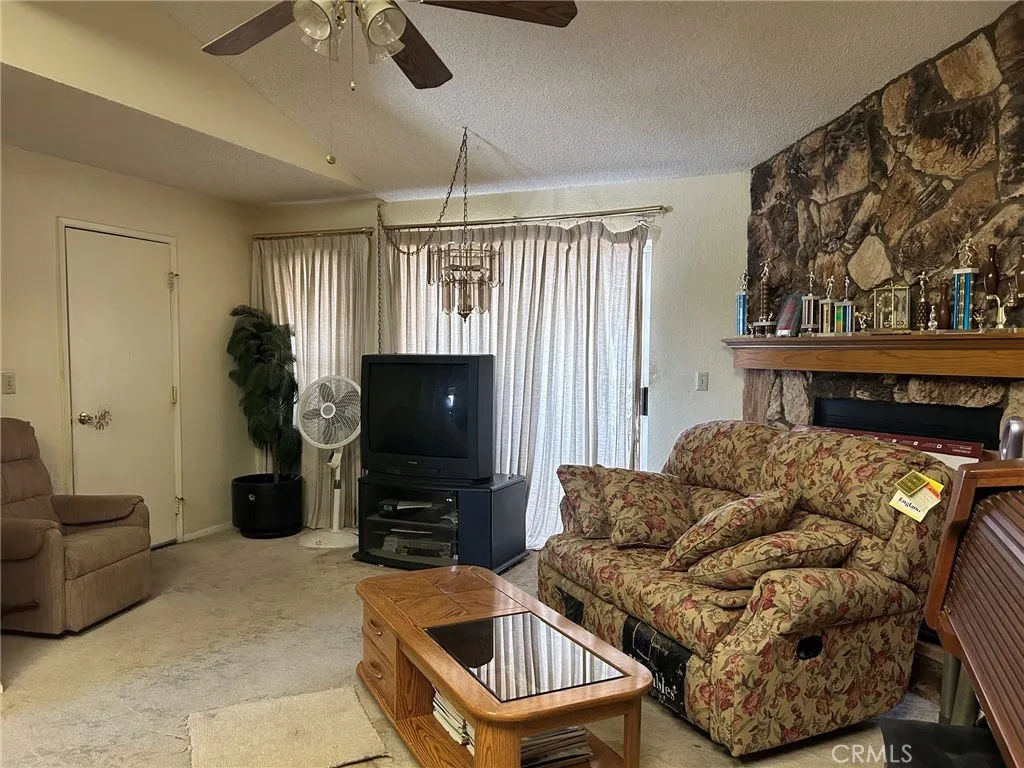 27250 Murrieta Road, Unit 347 Menifee, CA 92586 - Photo 2 of 38 a living room with furniture a flat screen tv and a fireplace