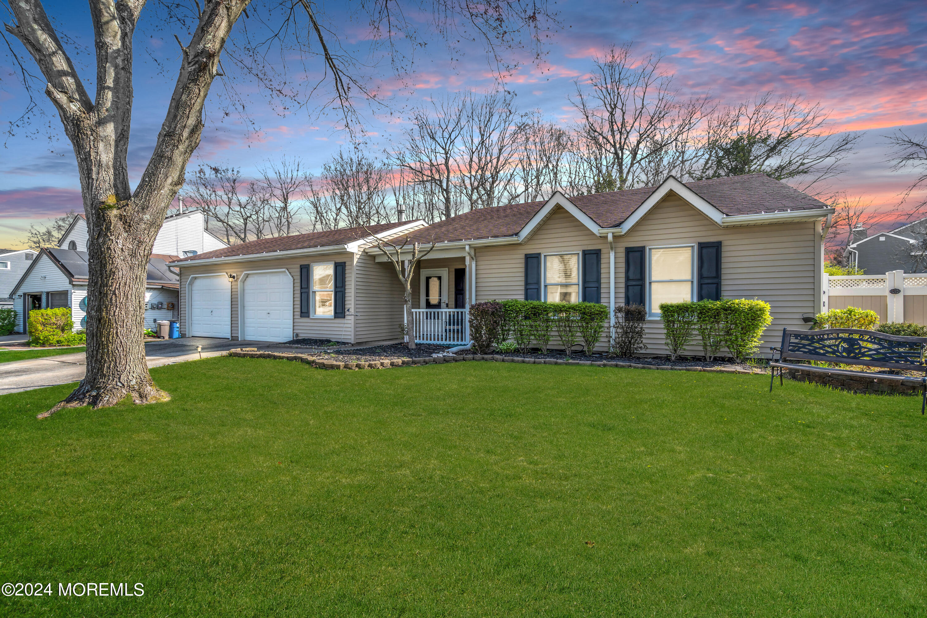 a front view of a house with a garden