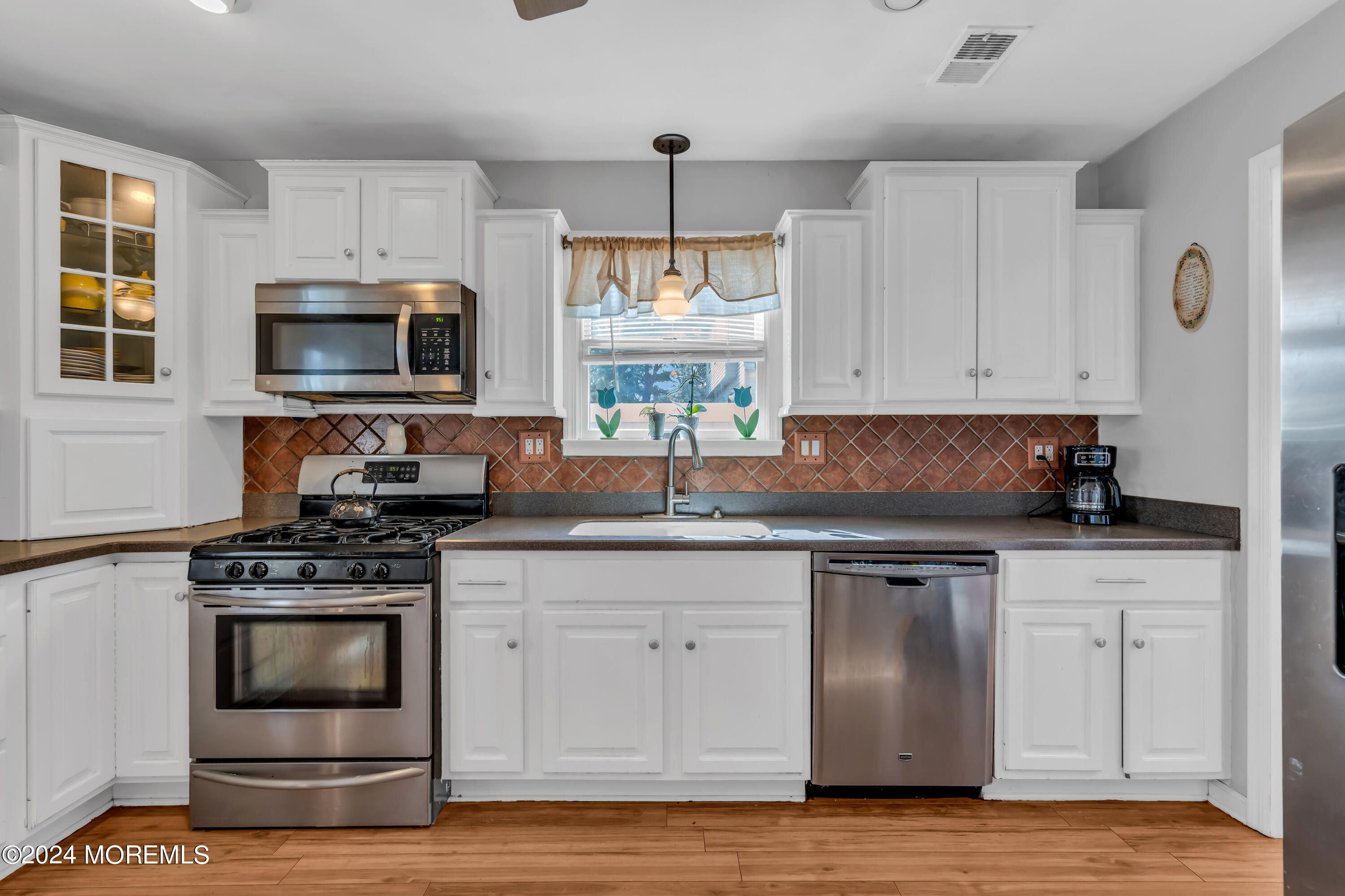 38 Concord Circle Howell, NJ 07731 - Photo 17 of 38 a kitchen with granite countertop a stove and a sink