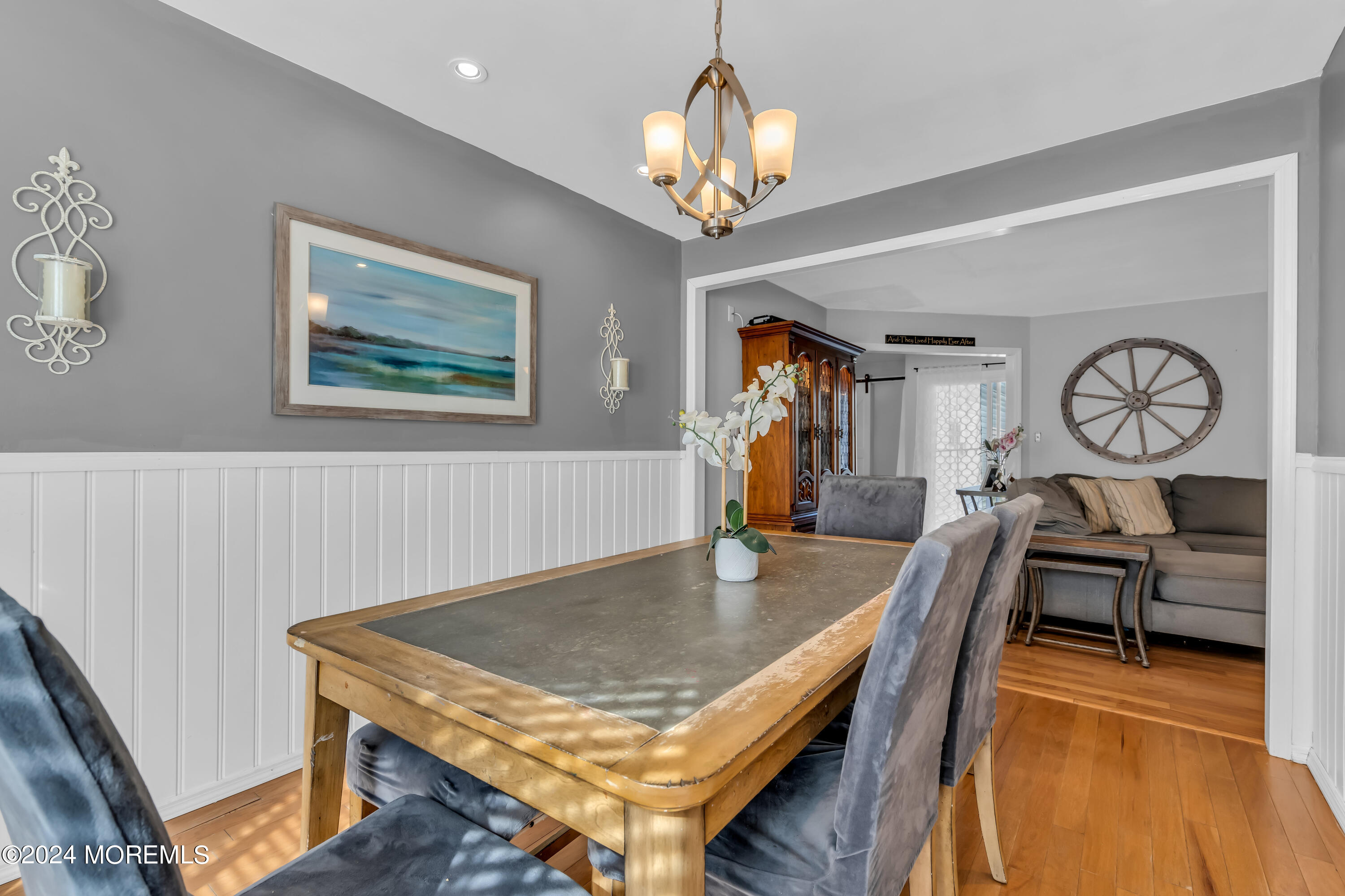 38 Concord Circle Howell, NJ 07731 - Photo 27 of 38 a dining room with wooden floor a chandelier a wooden table and chairs