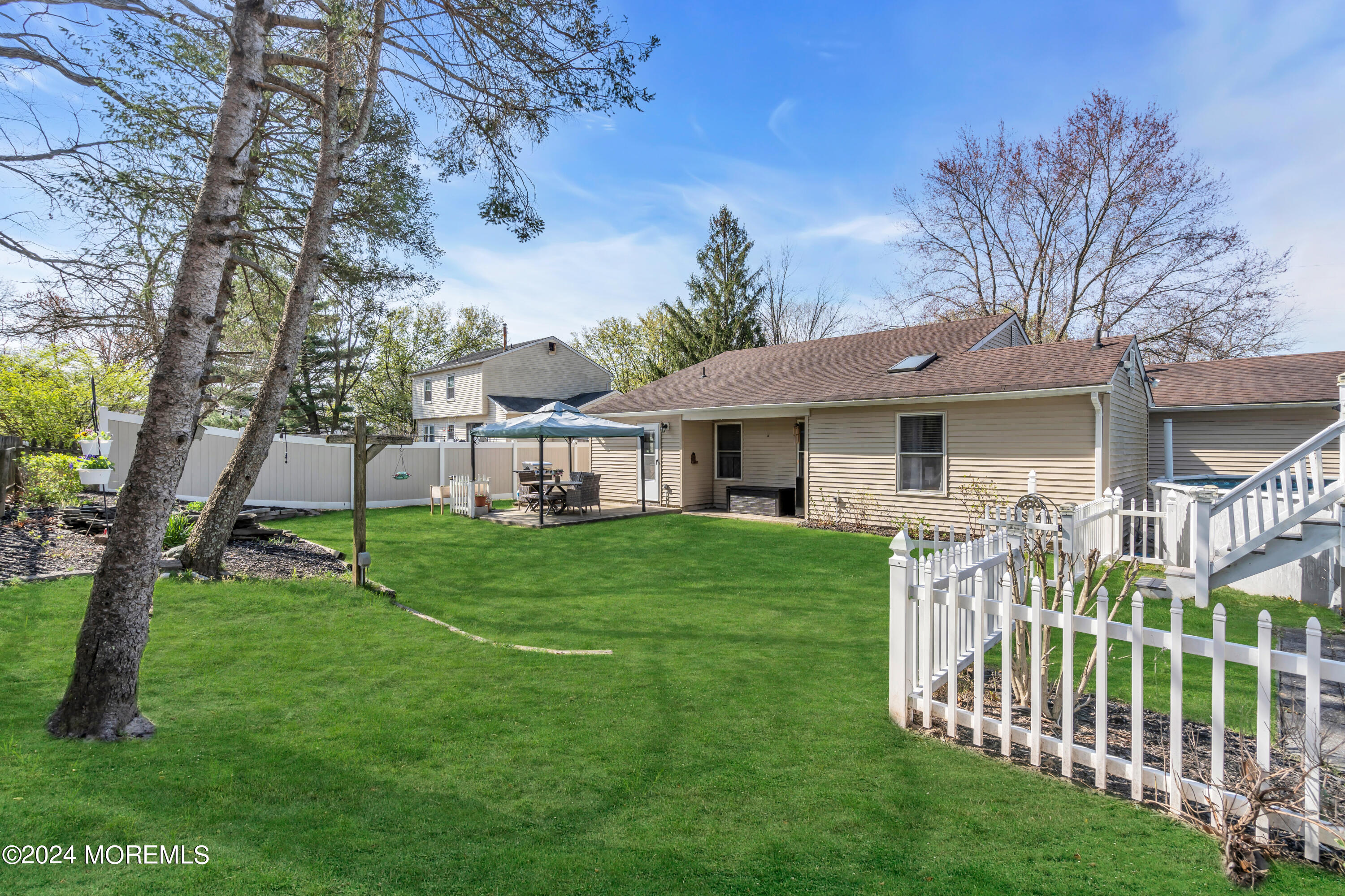 38 Concord Circle Howell, NJ 07731 - Photo 32 of 38 a front view of a house with a yard table and chairs