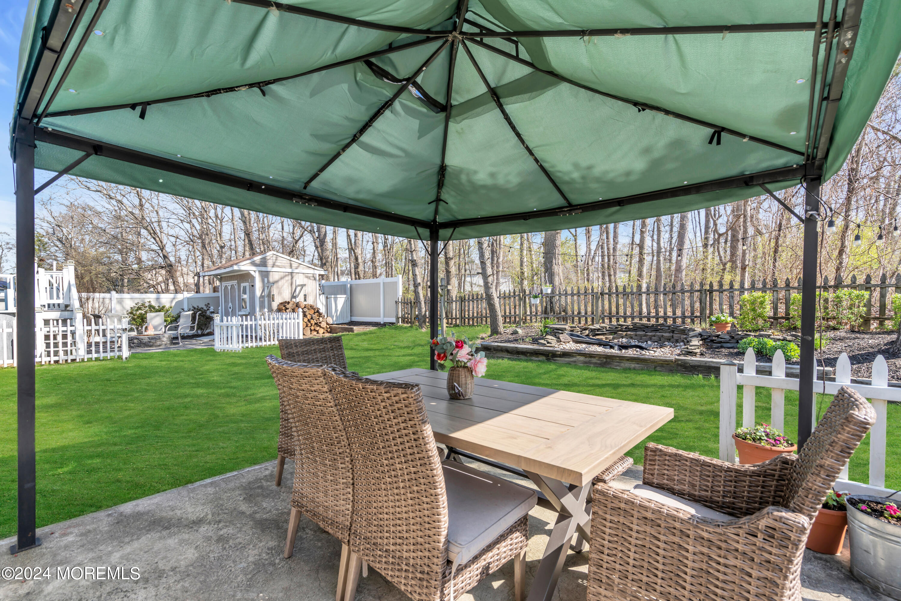 38 Concord Circle Howell, NJ 07731 - Photo 36 of 38 a view of yard with table and chairs under an umbrella
