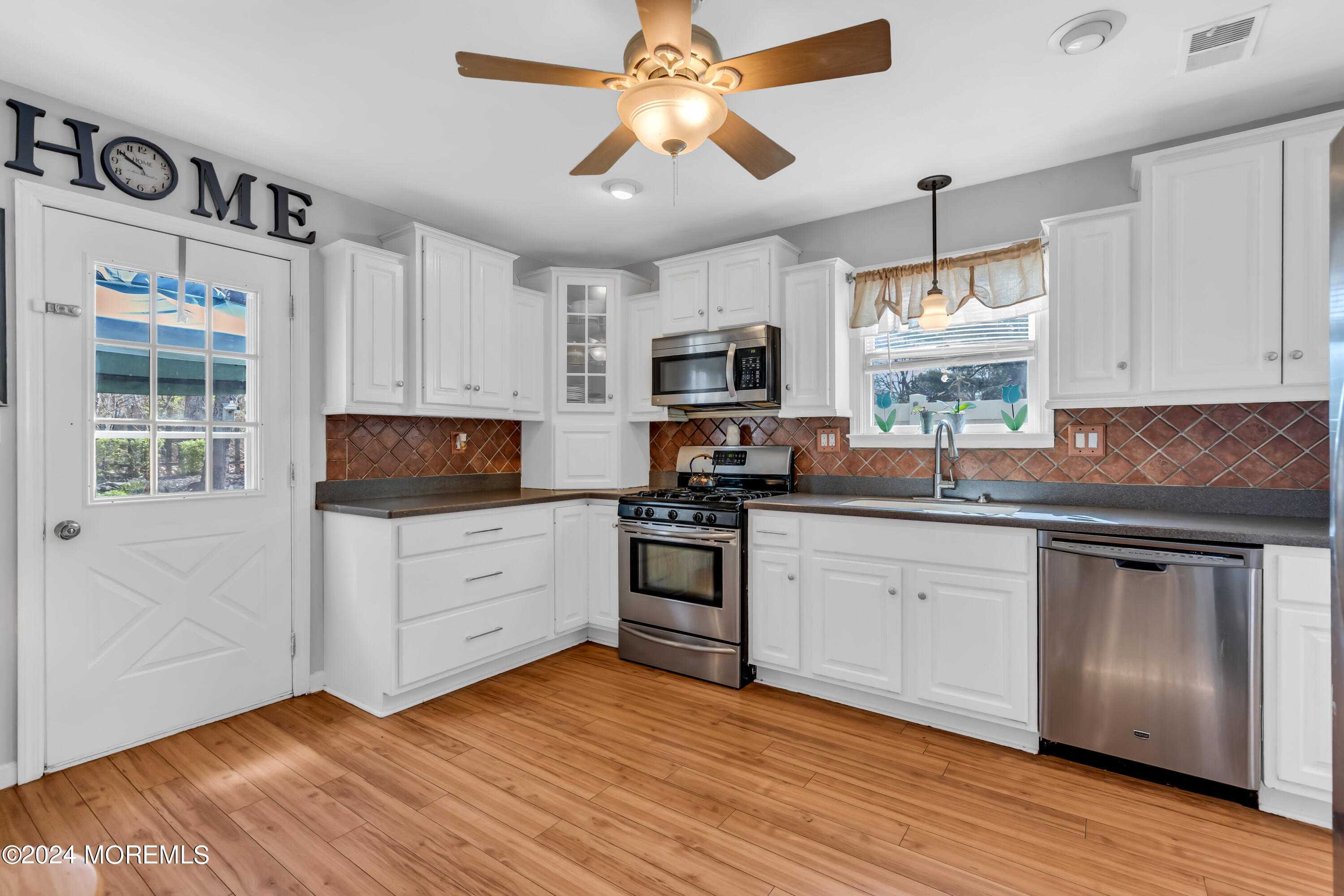 38 Concord Circle Howell, NJ 07731 - Photo 4 of 38 a kitchen with stainless steel appliances granite countertop a stove top oven a sink dishwasher and a refrigerator with wooden floor