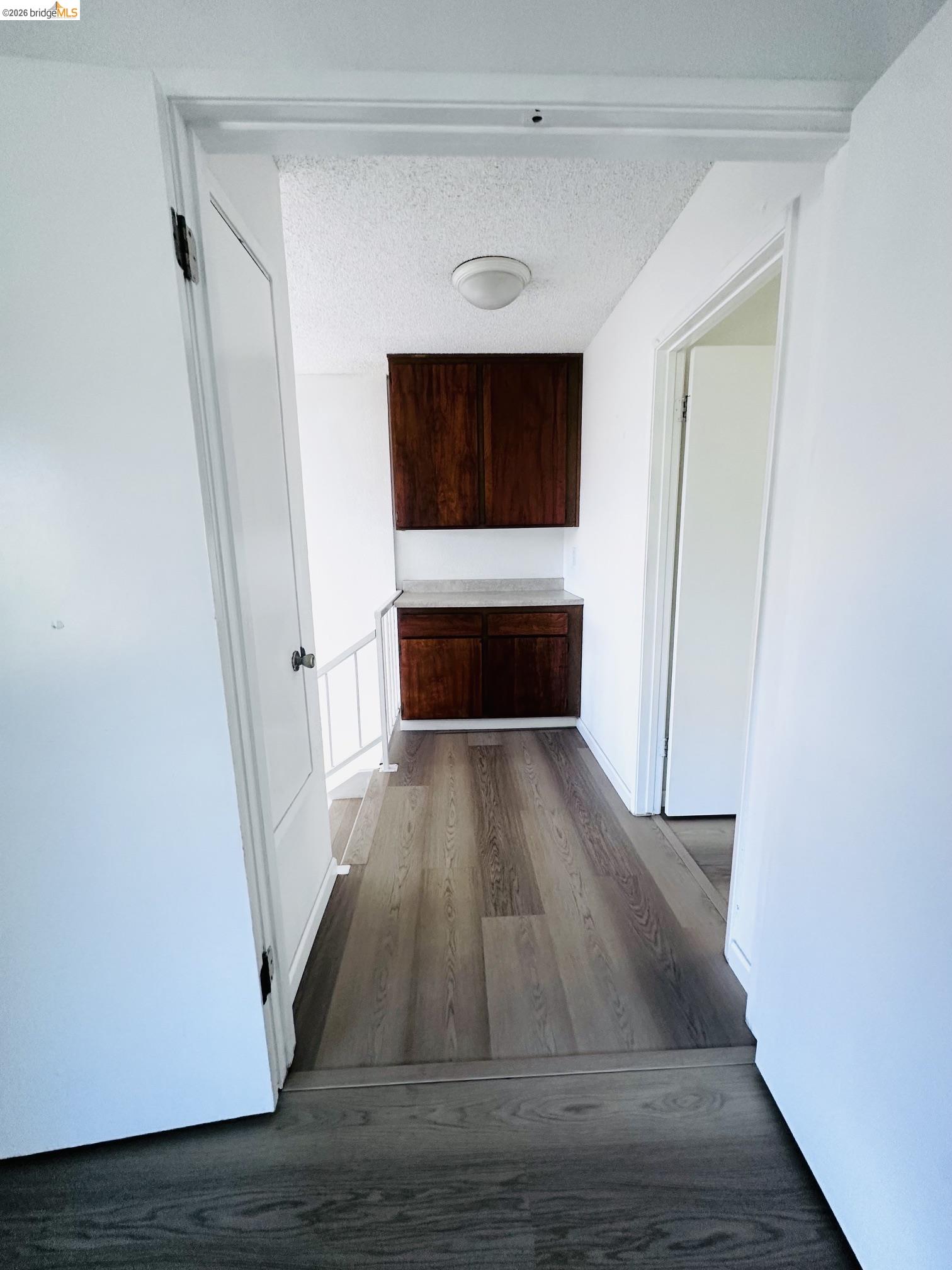 2121 Vale Road, Unit 50 San Pablo, CA 94806 - Photo 18 of 26 Wood-finish flooring, built-in cabinetry, and a ceiling-mounted light fixture